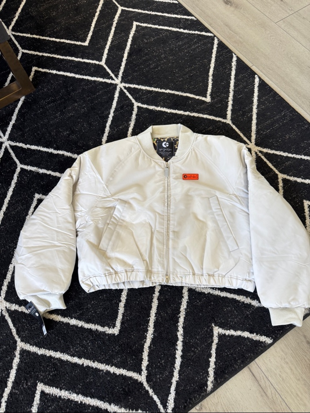 ethika White Bomber Jacket with Small Orange Patch